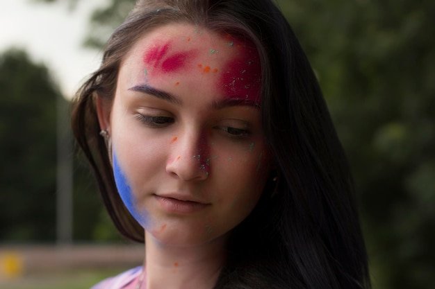 Portrait of brunette woman with dry powder on her face