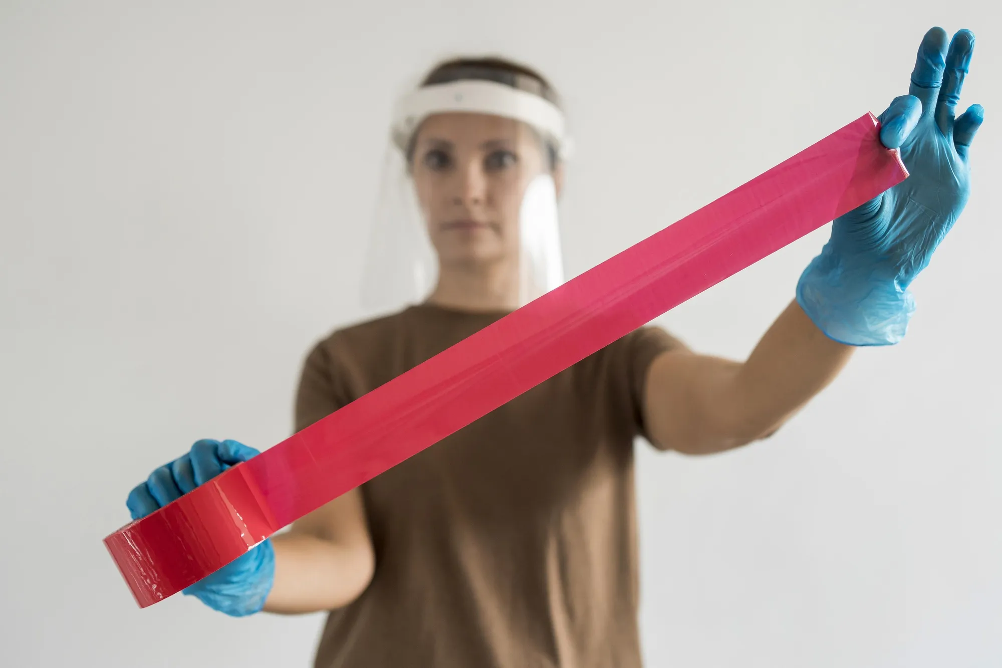 Woman with visor and tape