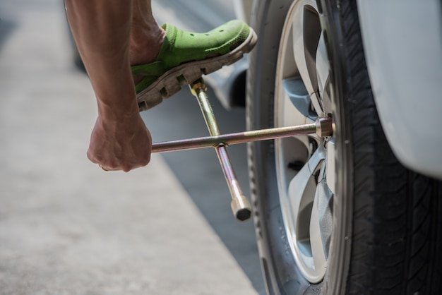 Changing a car tire, close up , car fixing and mainance service.