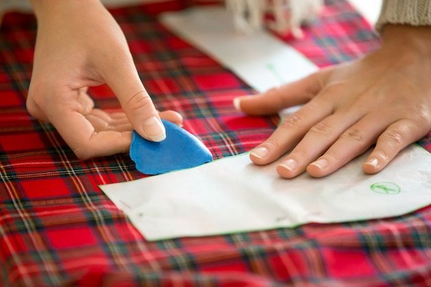 Hands working with a sewing pattern