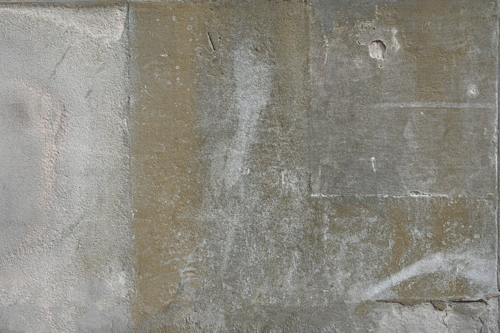 a white fire hydrant sitting on the side of a cement wall