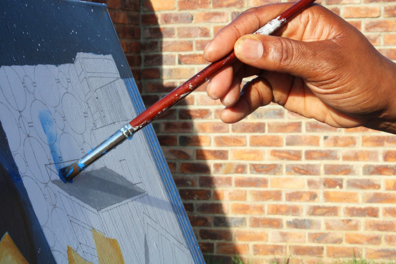 a person is holding a paintbrush and painting a picture