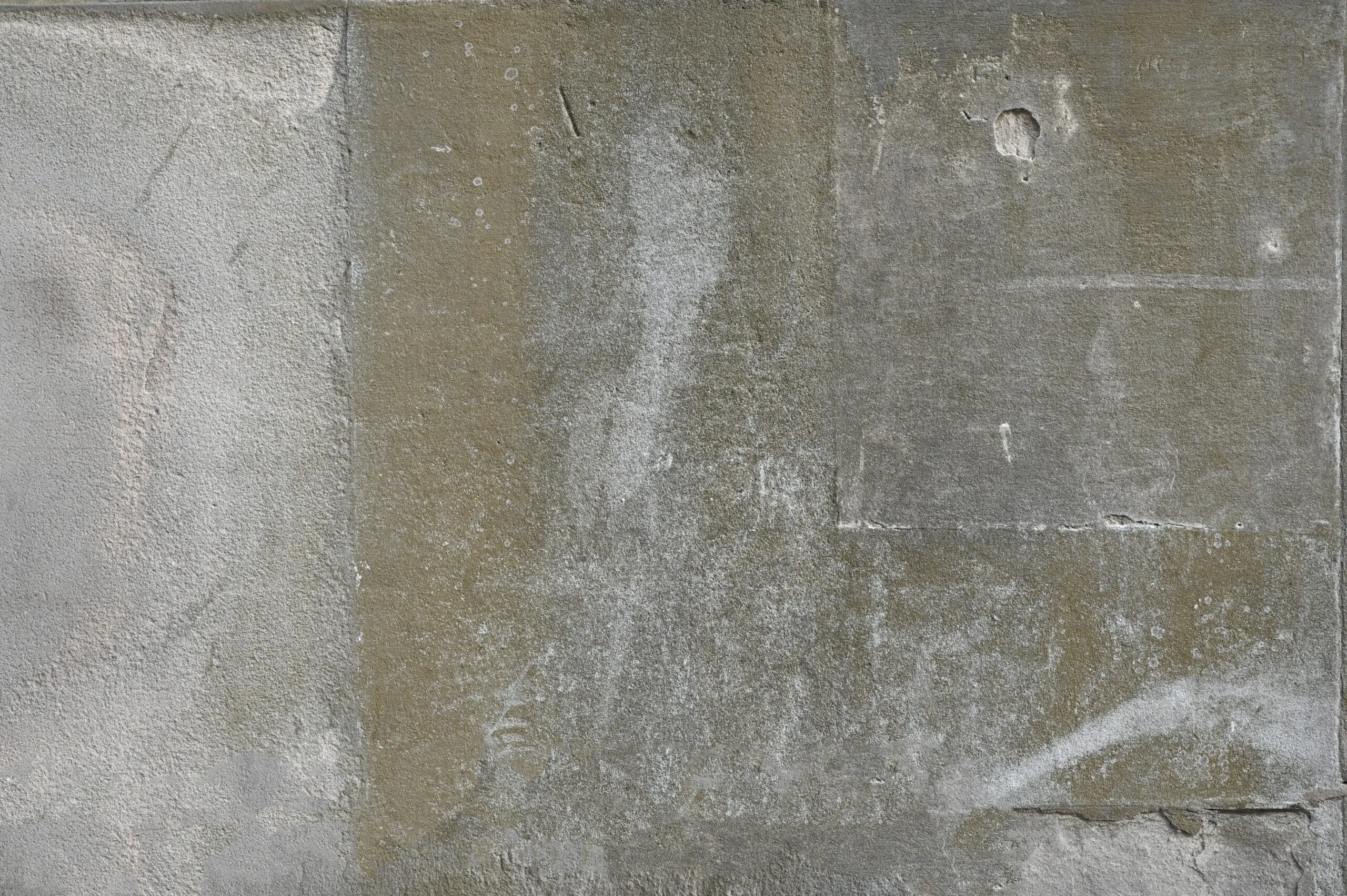 a white fire hydrant sitting on the side of a cement wall