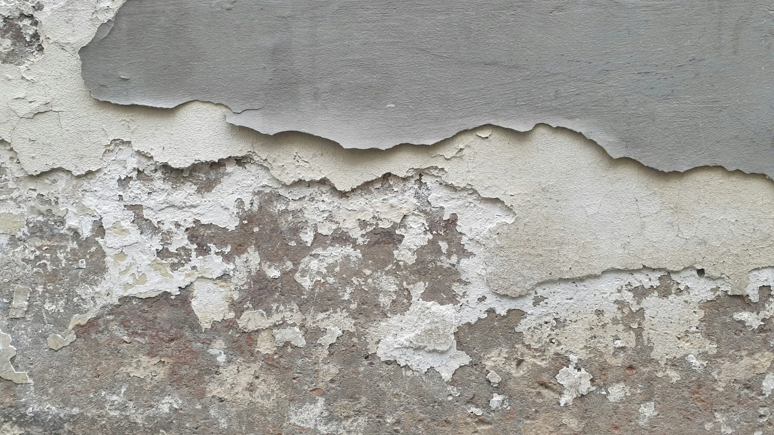 A close up of a wall with peeling paint