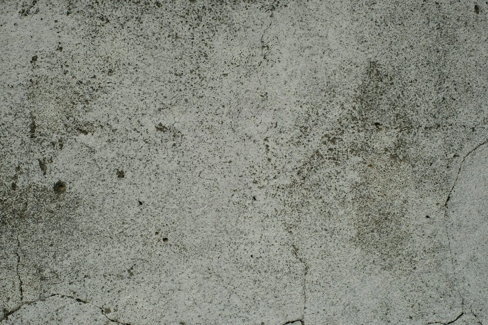A close up of a cement surface with small cracks