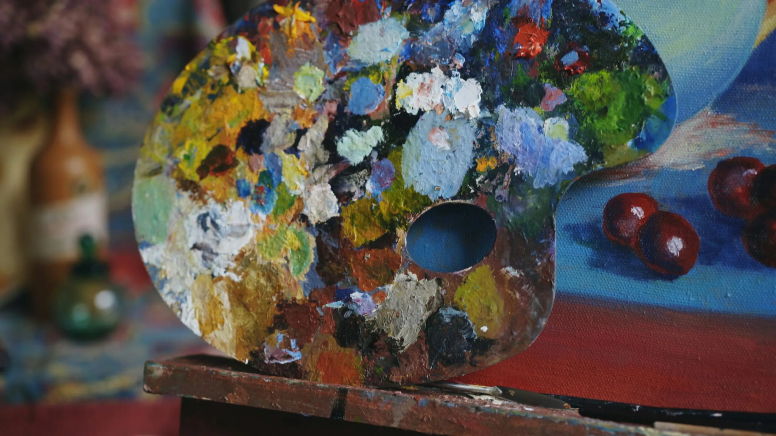 Artist's paint palette with colorful blobs of paints.