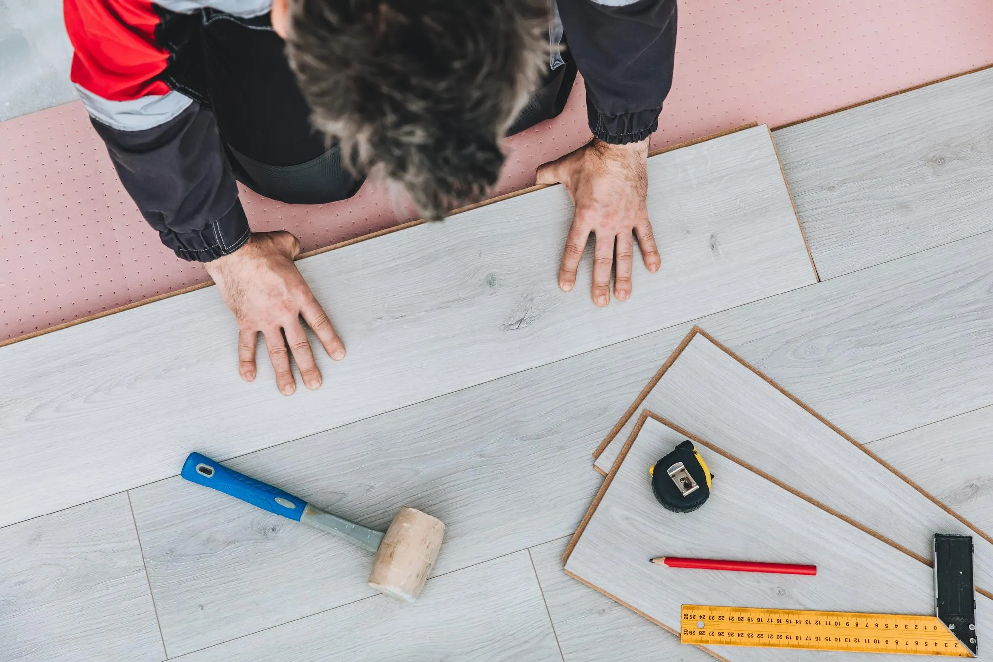 Man installing new laminated wooden floor