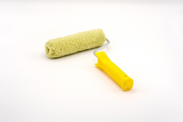 Roller paint brush on isolated white .
