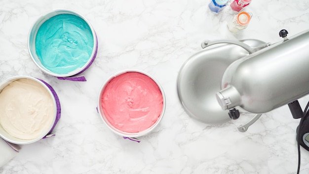 Step by step. Flat lay. Red, white, and blue cake batter in cake pans ready to be baked into the cake.