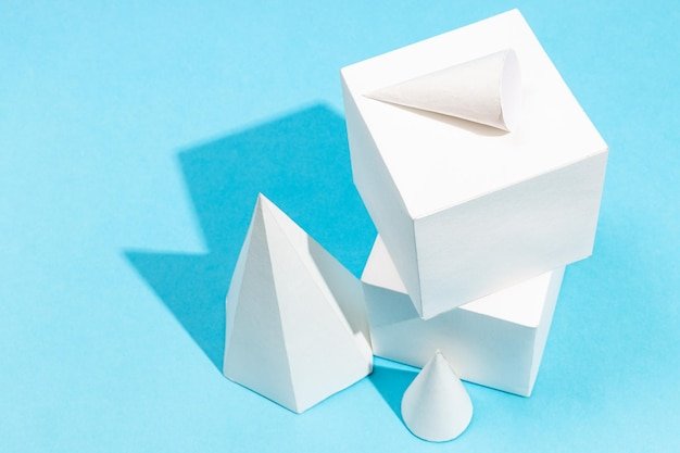 Top view of handmade geometric solids on blue