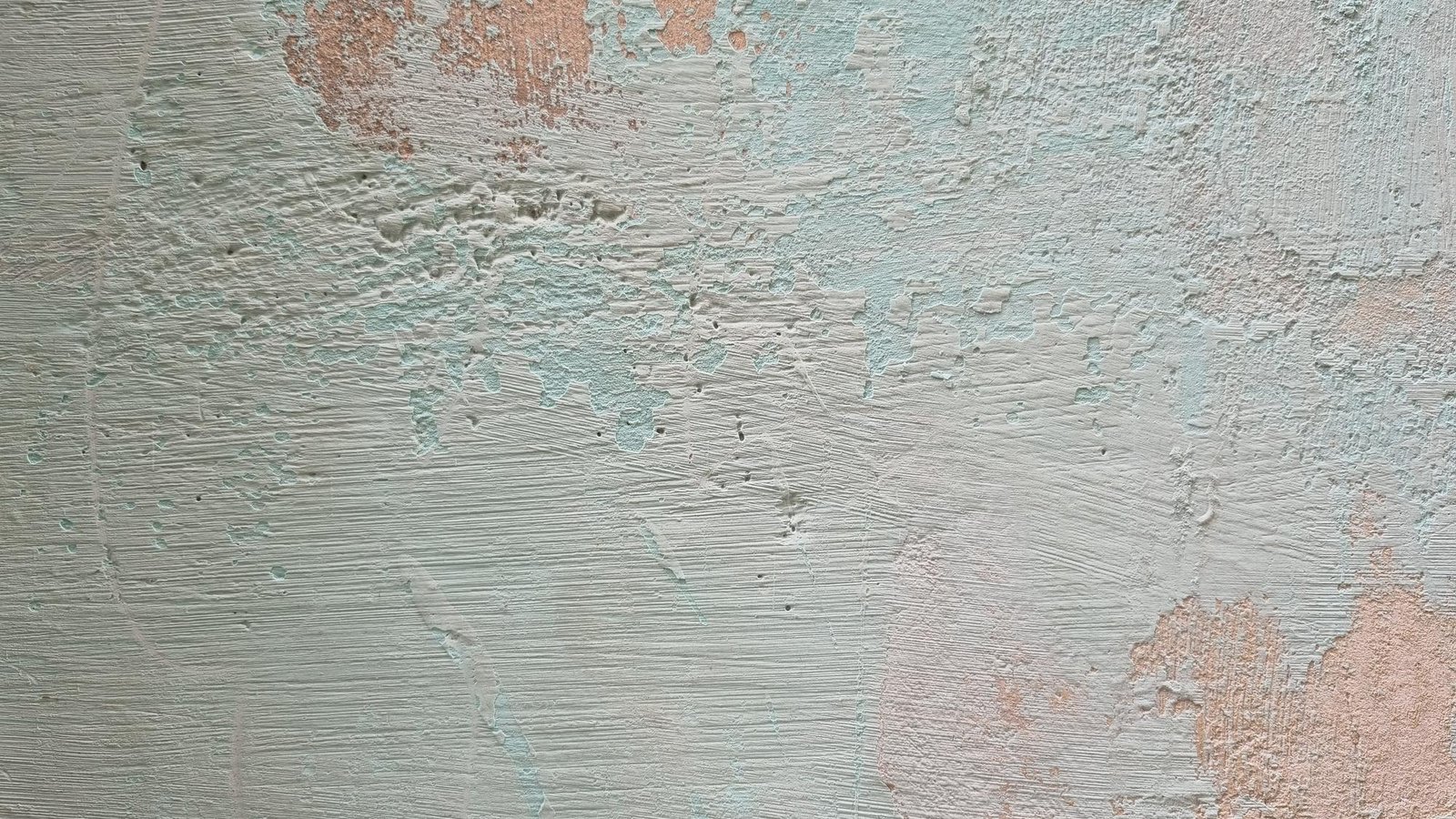 A wall with a blue and pink paint that has been painted on it.