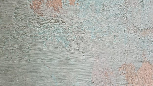 A wall with a blue and pink paint that has been painted on it.