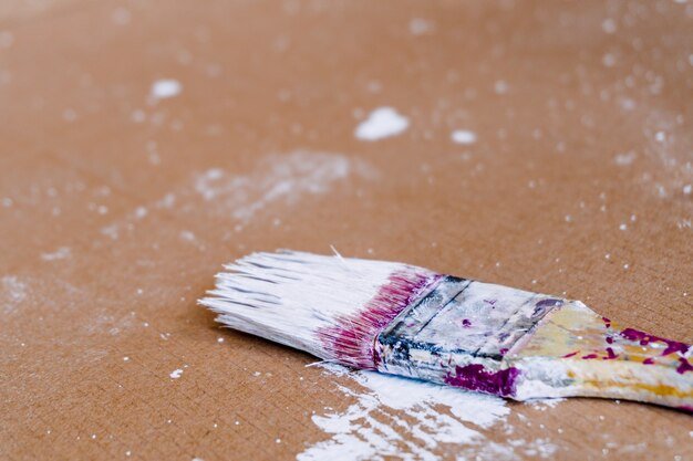 Closeup shot of a paintbrush on a brown