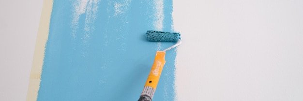 Hand painted wall painting walls with roller in blue repair of apartments