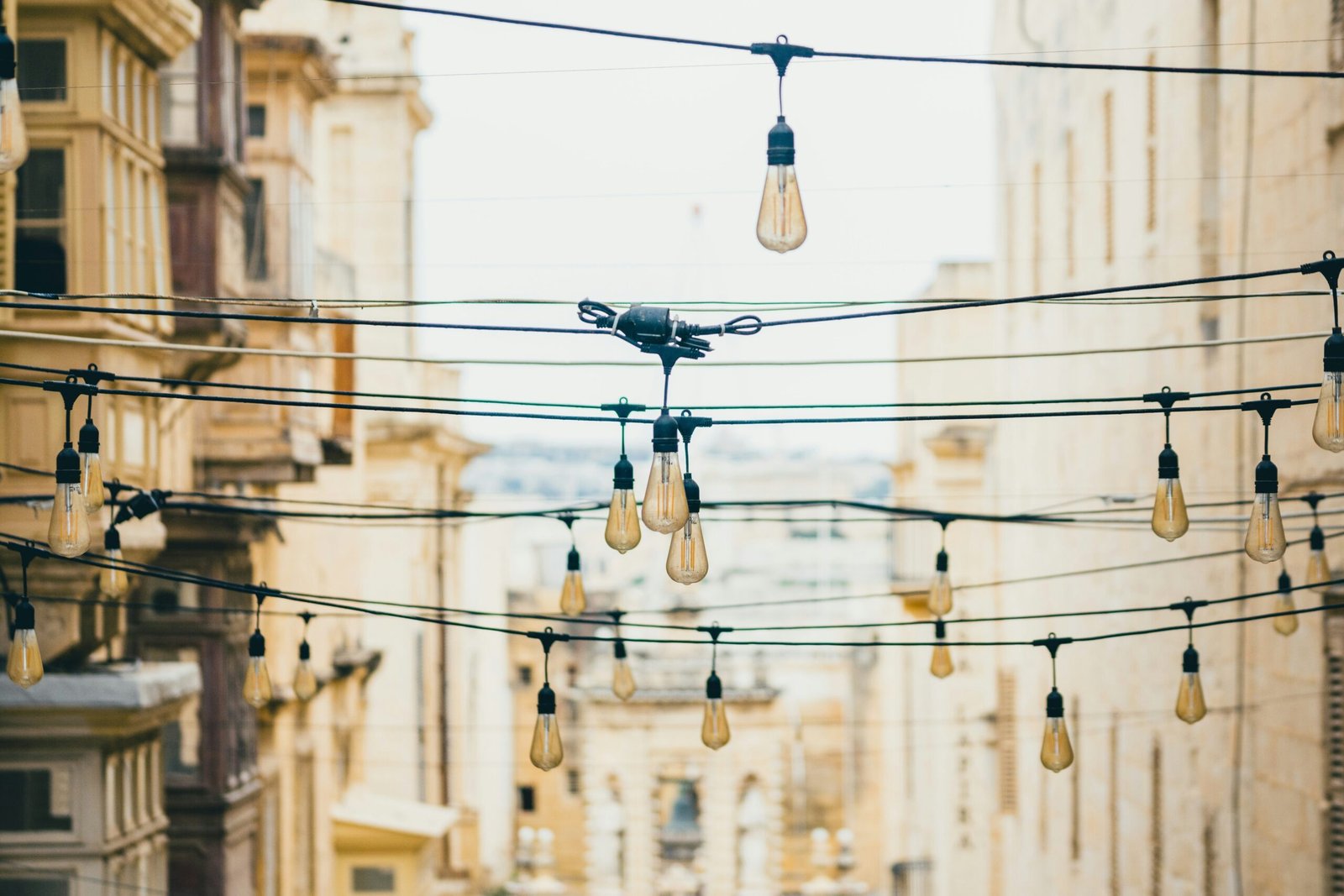 a bunch of lights that are hanging from wires