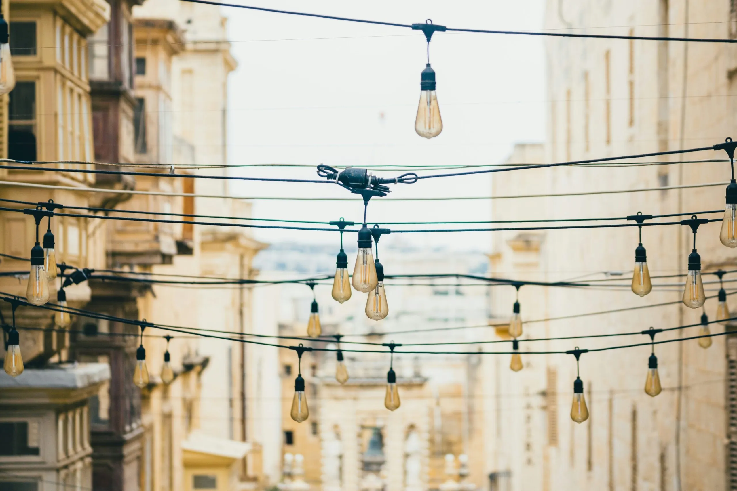 a bunch of lights that are hanging from wires