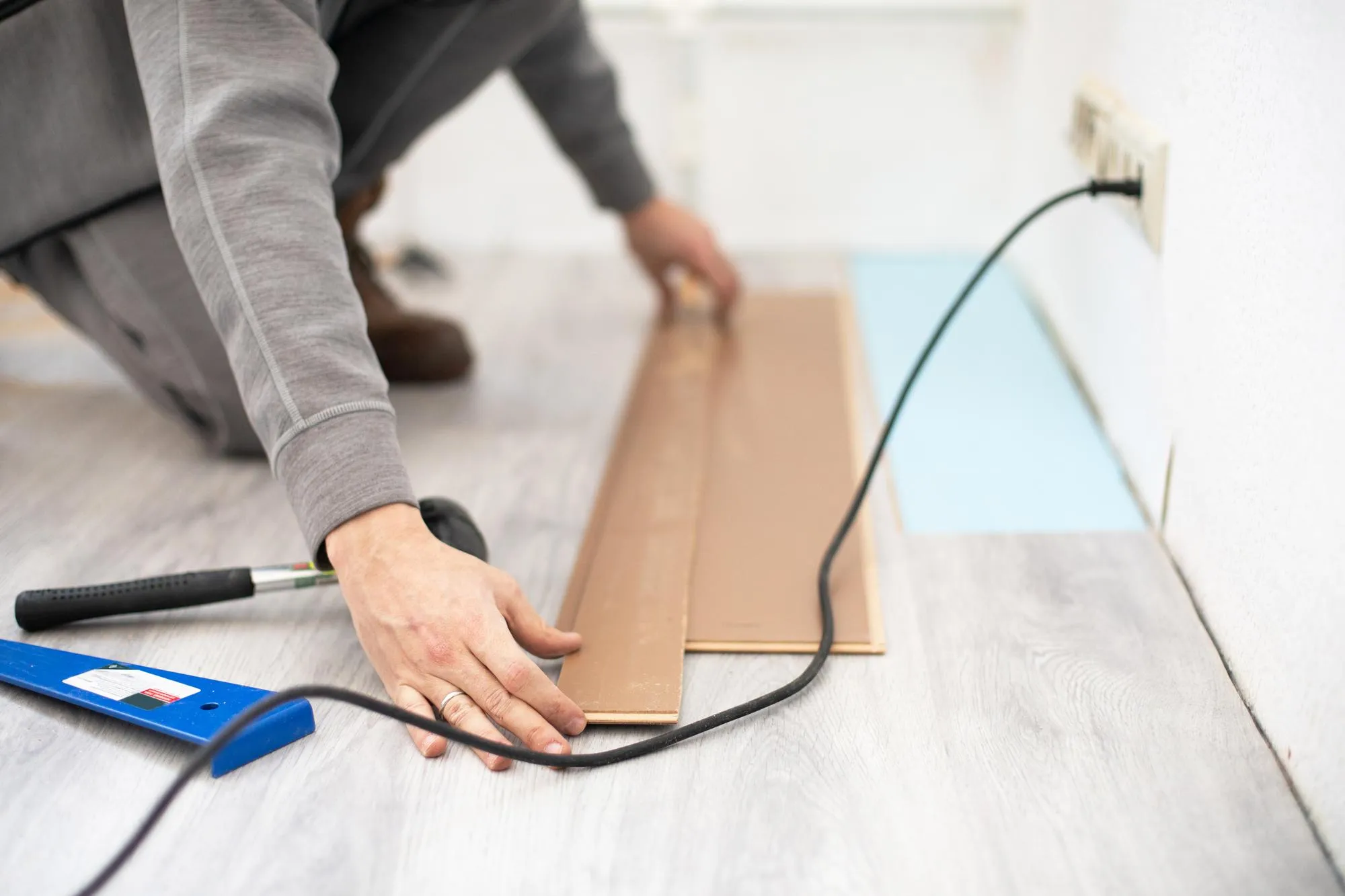 Laminate flooring renovation photo Measurement and cutting with saw tool