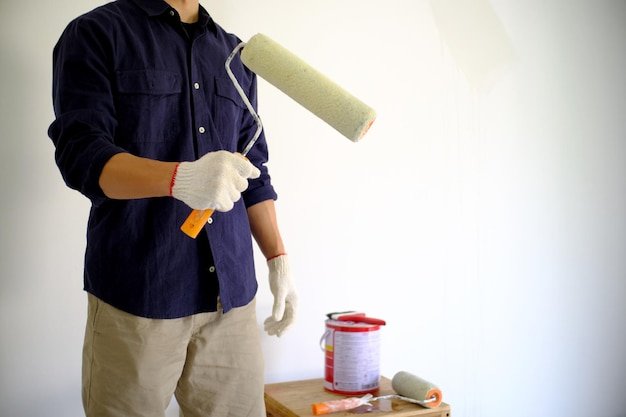 Man holding umbrella while standing on wood
