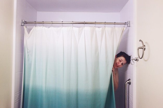 Portrait of young man standing on wall