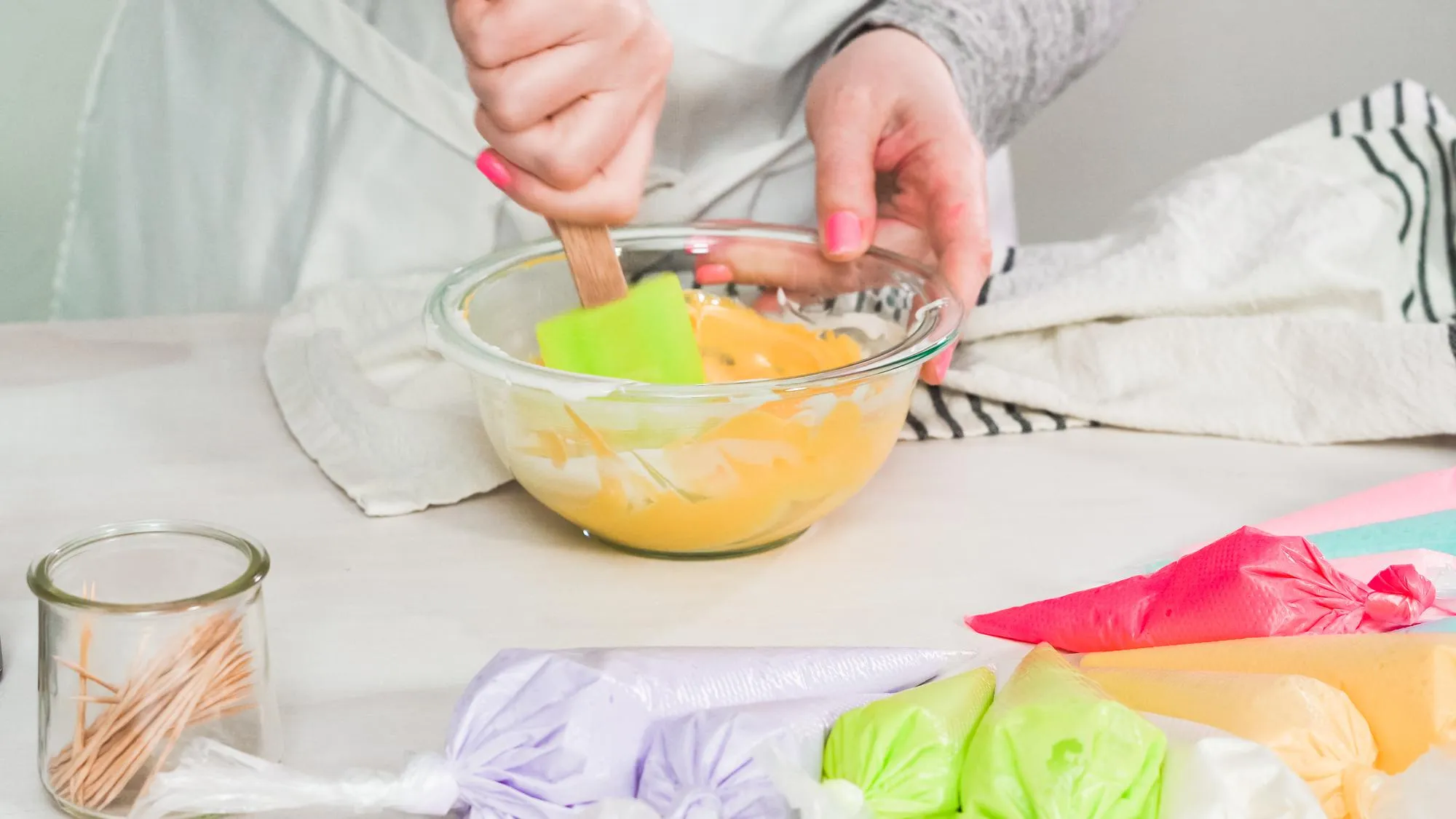 Step by step. Flat lay. Mixing royal icing to decorate Easter sugar cookeis.