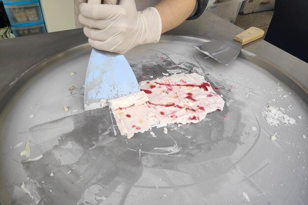 Stirfried ice cream being prepared on an ice pan