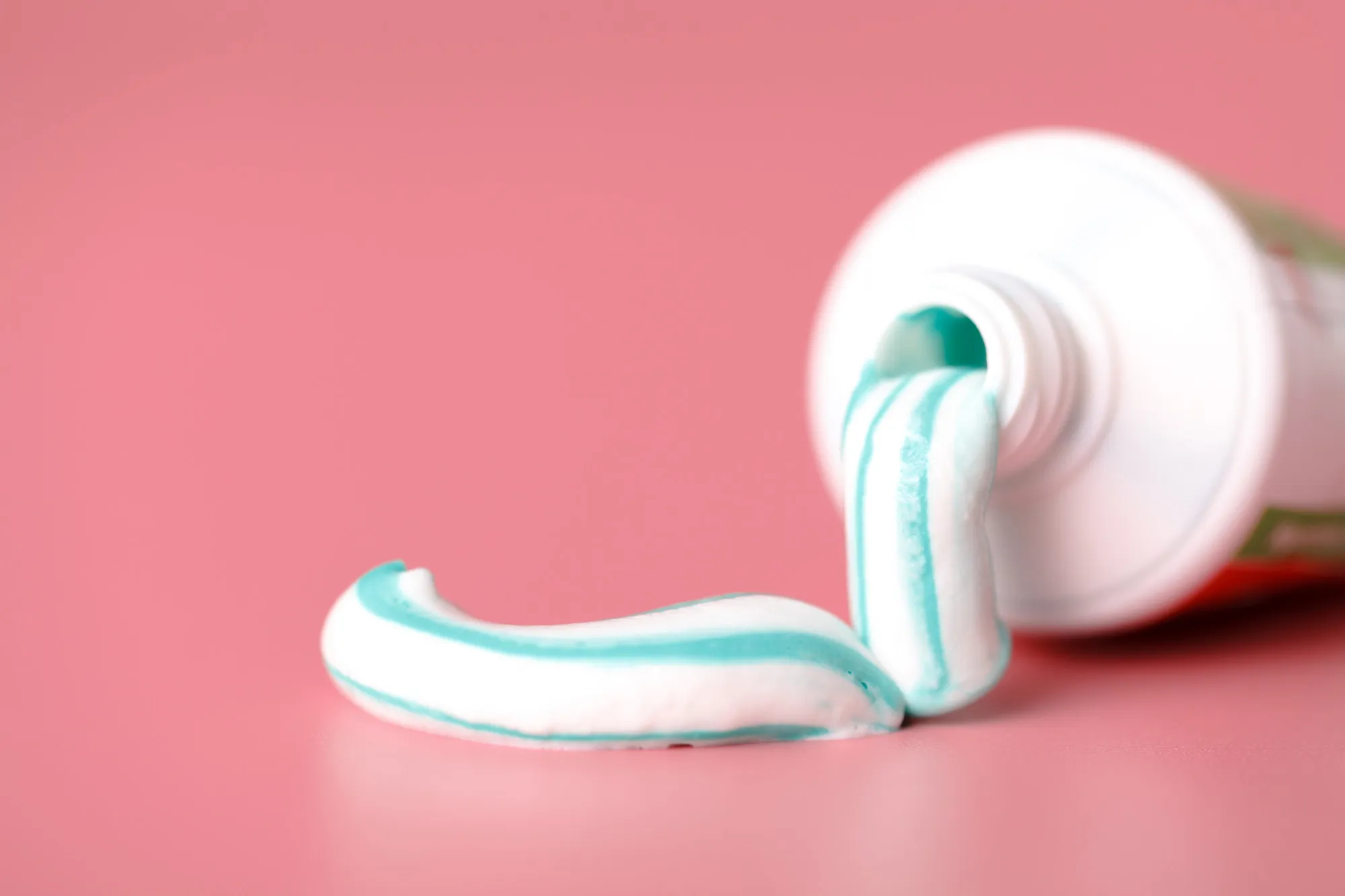 Tooth paste close up on pink