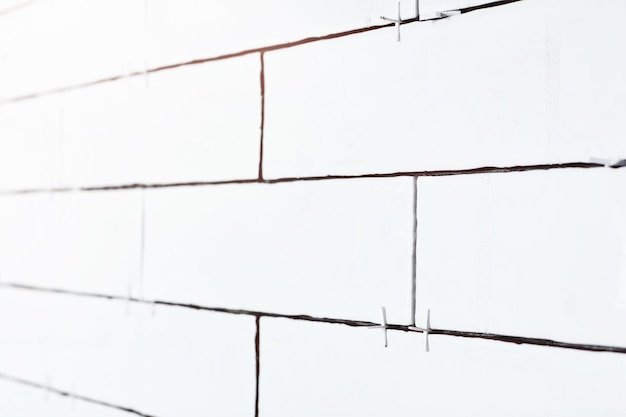 White light brick tiles wall texture wide background in rustic style Structure and pattern of destroyed stone grunge wall Retro style background Copy space