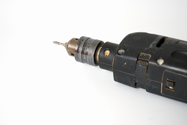 Black electrical drill on a white background