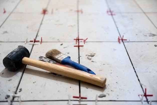 Ceramic tiles and tools for tiler  ceramic tiles installation  Home improvement, renovation   ceramic tile adhesive, mortar, level