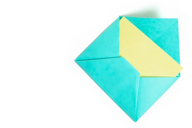 Envelope with yellow paper sheet isolated on white background with copy space for text