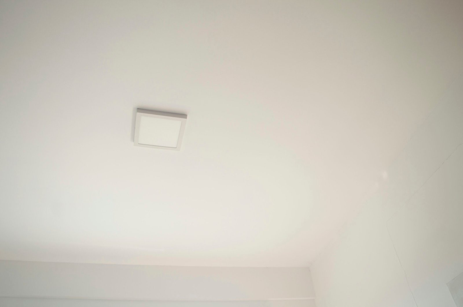 a bathroom with a toilet and a white ceiling