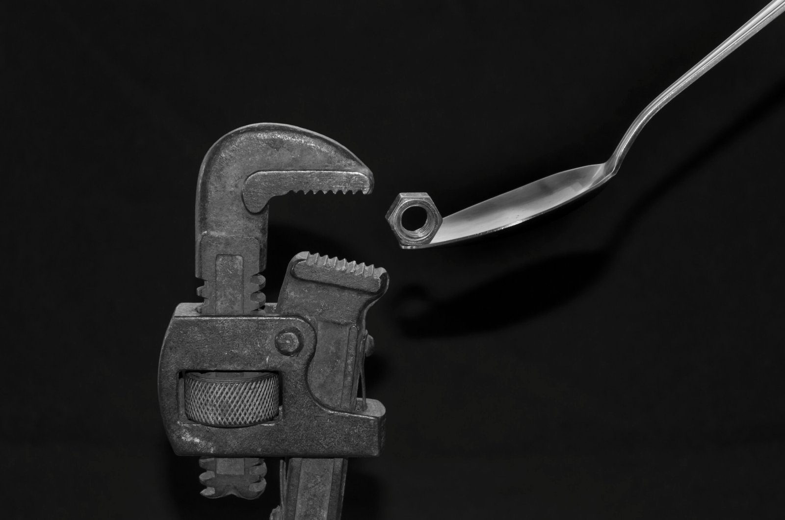 gray metal tool on black surface