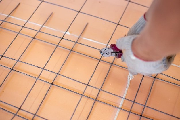Installation of underfloor heating Reinforcement welded mesh laid on polyurethane with sealed seams