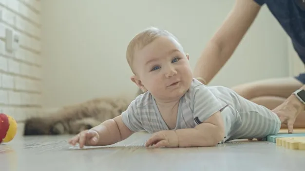 A little funny smiling baby on the floor looking in the camera