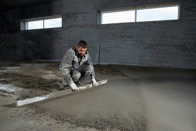 Man filling the floor with concrete