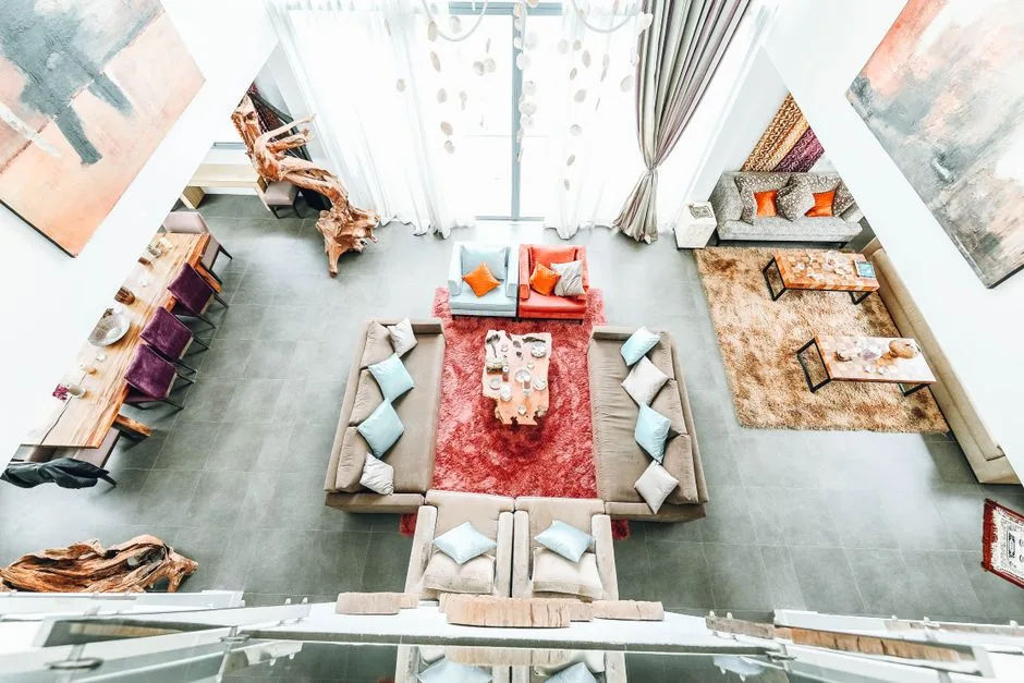 Bright, spacious living room with contemporary design, featuring cozy sofas and vibrant decor elements.
