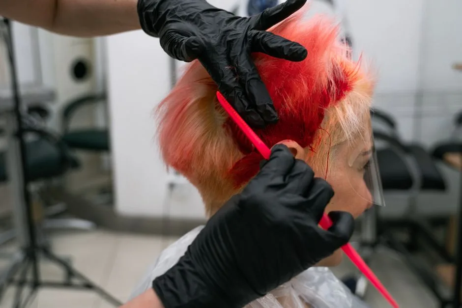 Close-up of a vibrant hair coloring process in a salon, showcasing expertise and trendy style.