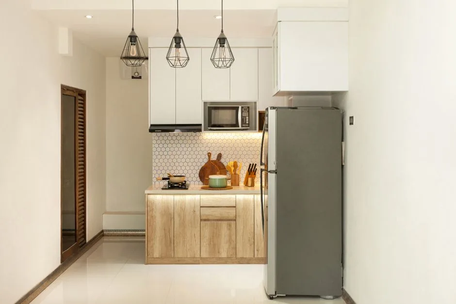Stylish minimalist kitchen interior with wooden cabinets and sleek appliances.