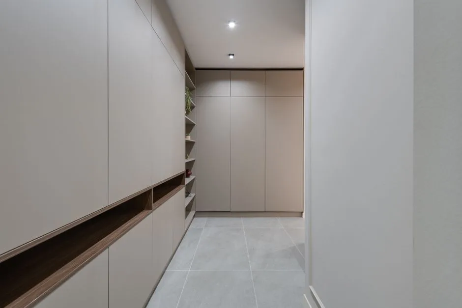 Explore a contemporary minimalist hallway featuring sleek modern cabinetry and neutral colors.