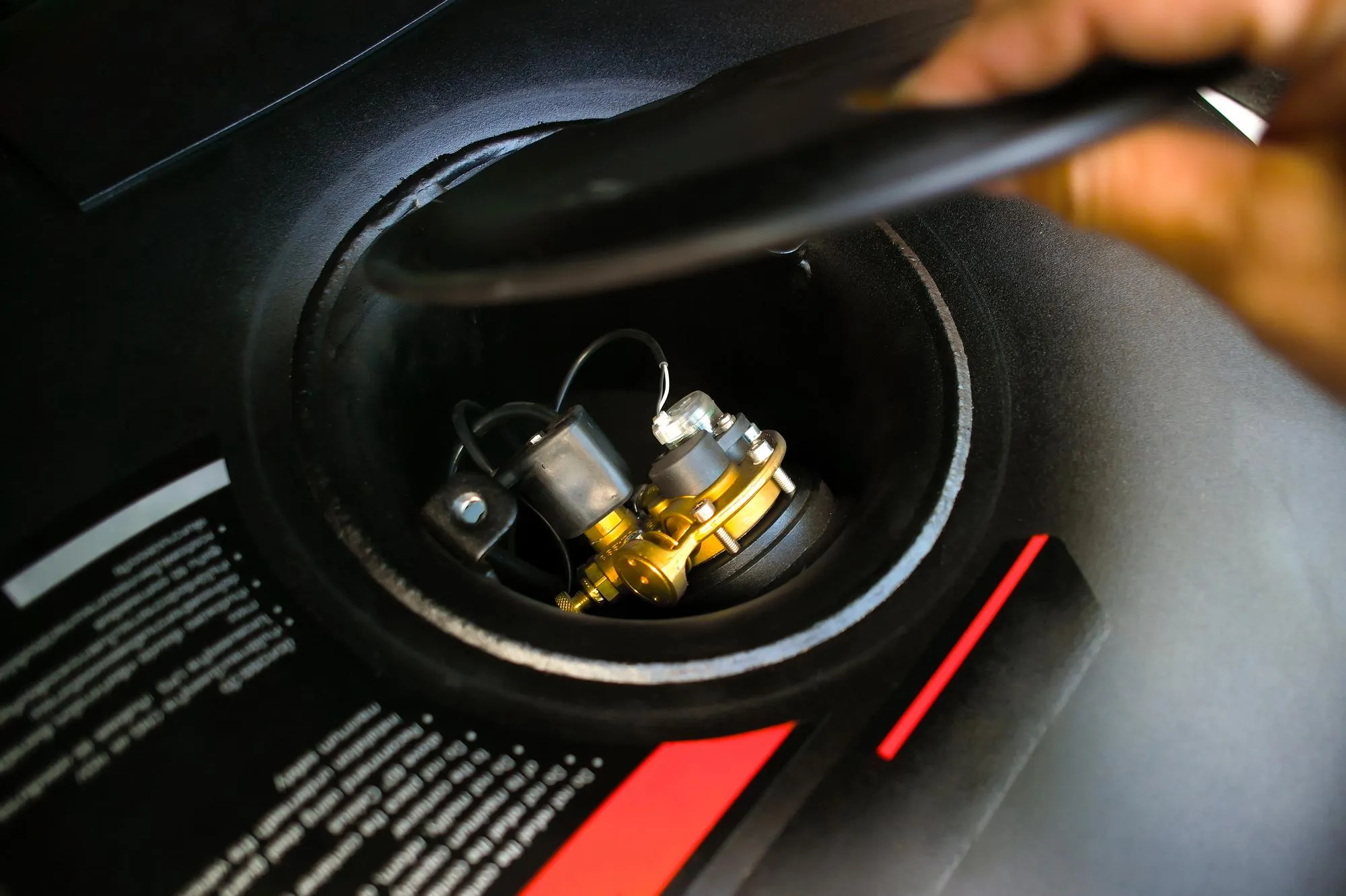 Propane or LPG multivalve of LPG container black circle shape on spare wheel holder in trunk car Automotive alternative energy concept