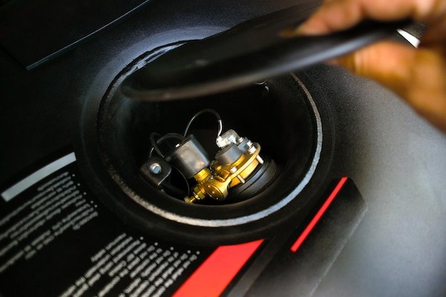 Propane or LPG multivalve of LPG container black circle shape on spare wheel holder in trunk car Automotive alternative energy concept