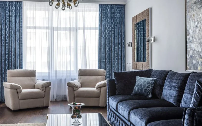 Interior of modern living room with comfortable sofa with pillows and soft armchairs