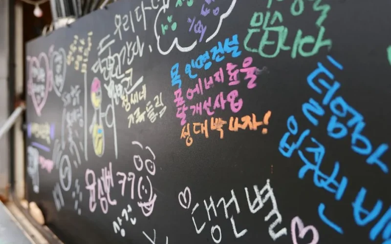 Vibrant chalk messages and drawings on a blackboard, showcasing expressive handwriting.