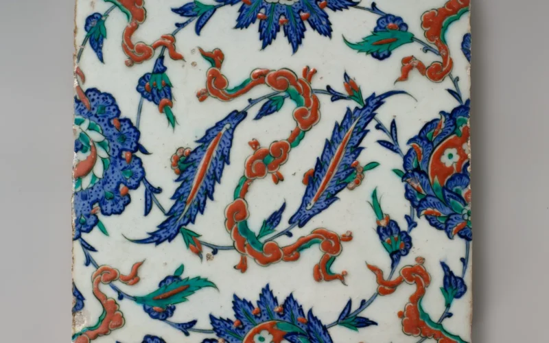 Restorations to Istanbul’s Topkapi Palace after 1574 resulted in major commissions for ceramic tiles. Designed in the imperial workshop in Istanbul, these tiles were executed at the famous kilns of Iznik. This example, when aligned with others of its type, forms a pattern of four floral palmettes, interspersed with red, ribbonlike cloud bands. Many of these tiles remain in situ, having adorned the walls of the Ottoman palace for more than four centuries. Subjects: Turkey; Iznik; ca. 1578; Marmara; Metropolitan Museum of Art; Glaze; Asia; Islamic; Bursa; Tile; Stonepaste; polychrome painted under transparent glaze; Painting; Ceramics