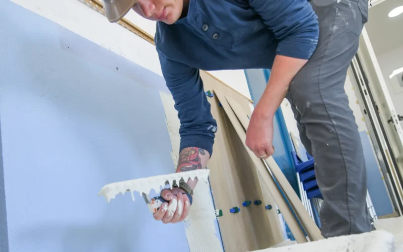 ROTA, Spain (May 22, 2024) - U.S. Navy Builder 3rd Class Samuel Czepiel, assigned to Naval Mobile Construction Battalion (NMCB) 11, applies tile adhesive during a community relations project for the Association of People with Disabilities in Rota, Spain, May 22, 2024. NMCB 11, assigned to 22 Naval Construction Regiment, is forward deployed across the U.S. Naval Forces Europe-Africa area of operations, providing civil engineering support for U.S. 6th Fleet maritime operations to defend U.S., Allied, and partner interests. (U.S. Navy photo by Mass Communication Specialist 2nd Class James S. Hong)