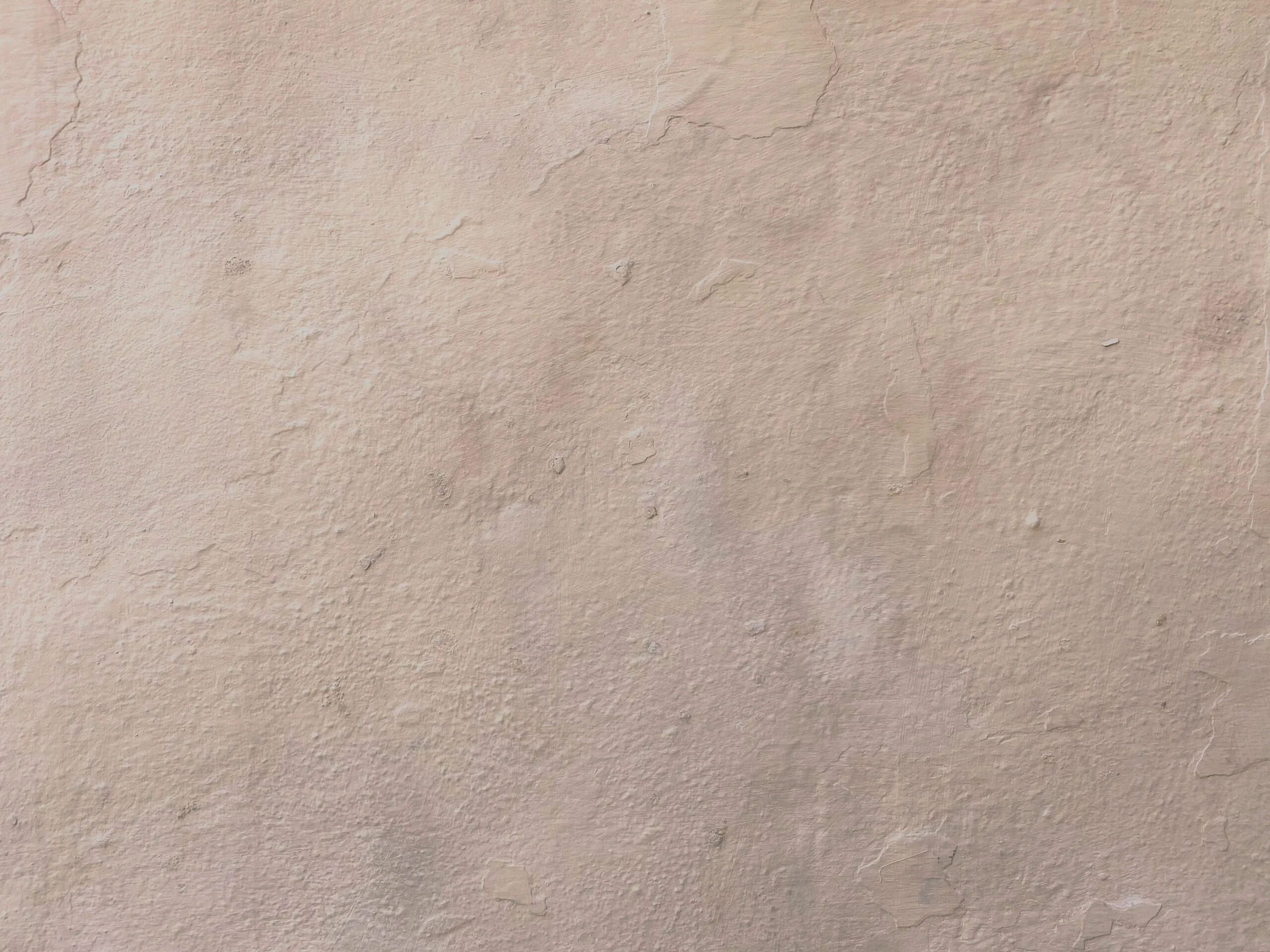 Close-up of a beige textured plaster wall surface, ideal for backgrounds.