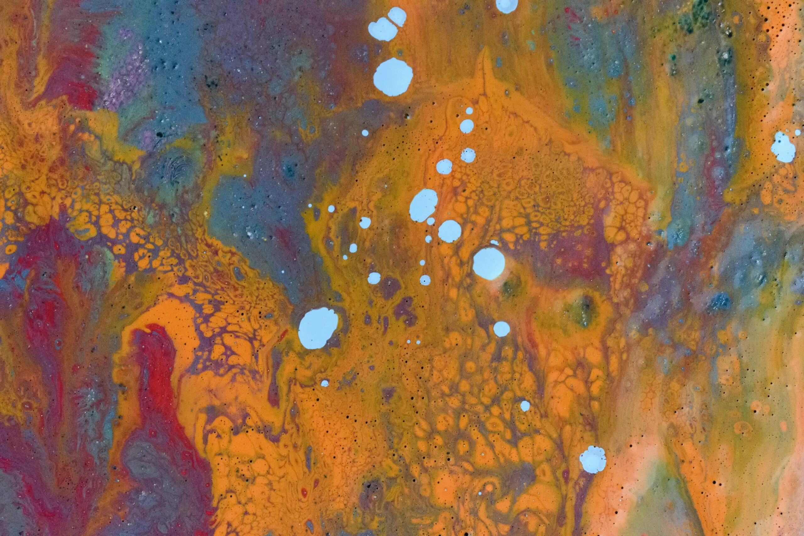 Vivid fluid art painting with orange, blue, and purple abstract patterns.