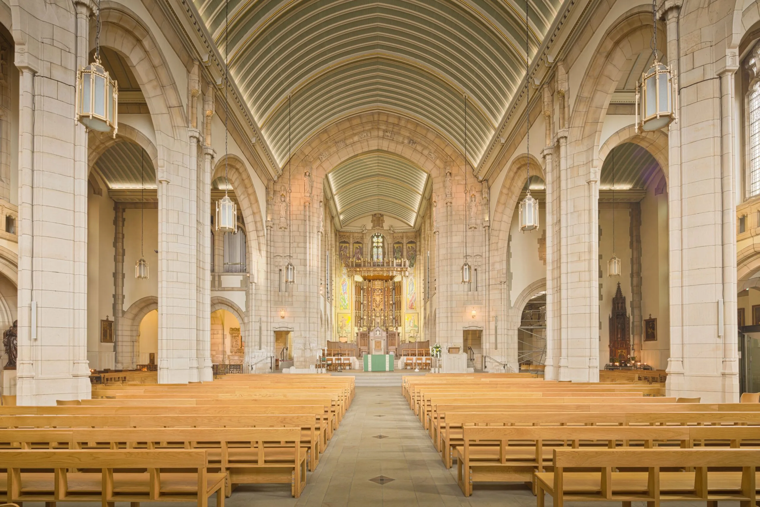 Interior view of a historic cathedral's nave with gothic arches and intricate detailing in England, UK.