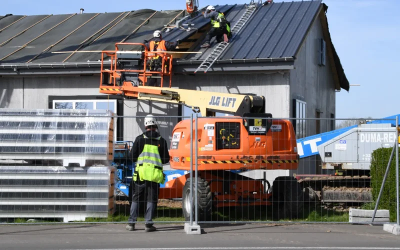 Contractors with Belgian construction firm “Toitures Bernard” install freestanding roof sandwich panels during renovation of Bldg 20029 on Chièvres Air Base, Belgium, April 11, 2022. (U.S. Army photo by Henri Cambier)