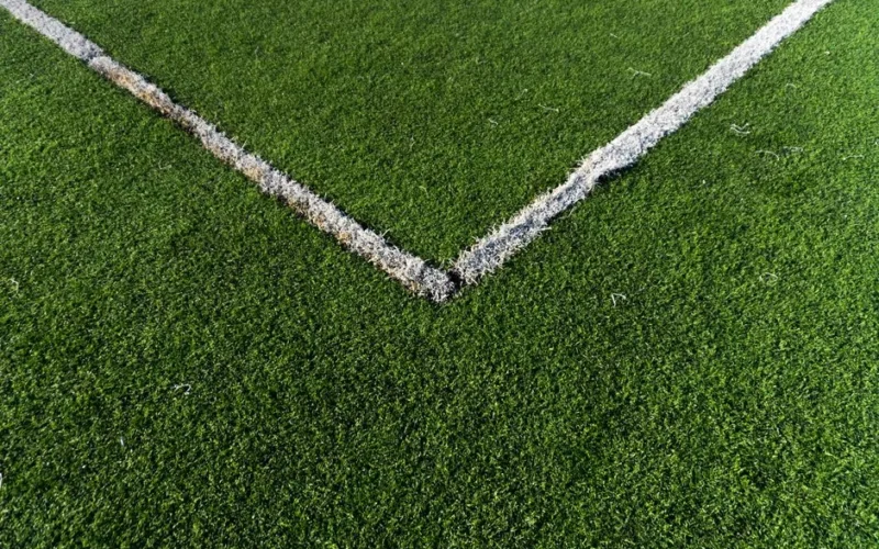 Detailed view of a soccer field corner with vibrant green artificial turf in Istanbul.